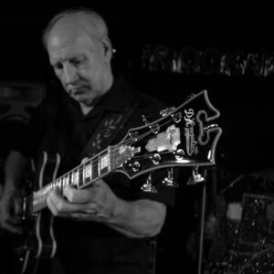 Man playing a guitar on stage